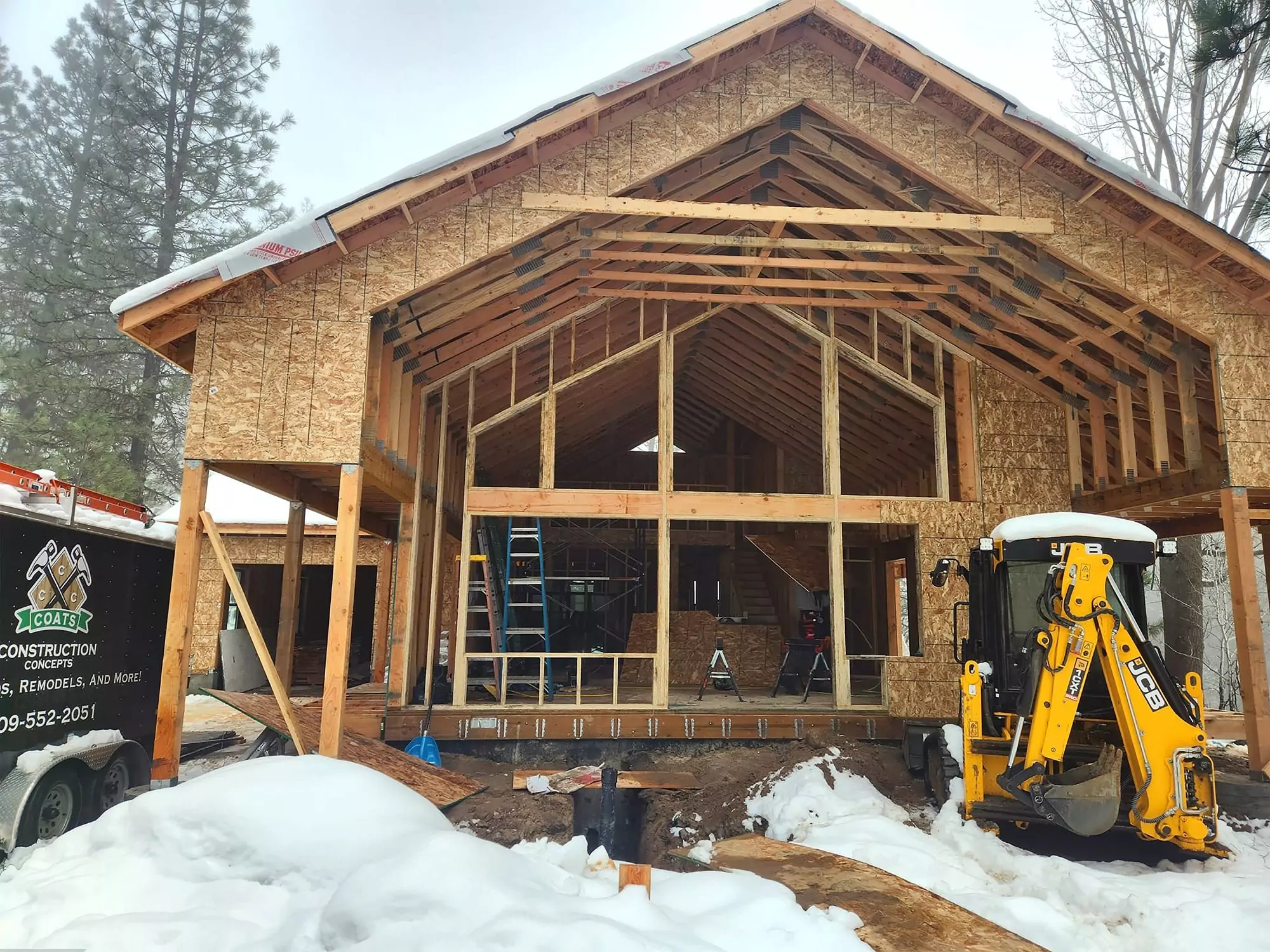 Coats Construction Concepts- Front of house with small tractor and Coasts trailer